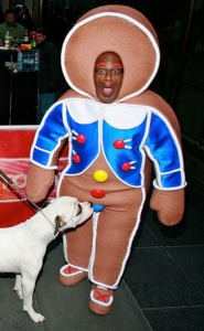 Al Roker as a Gingerbread man getting sniffed by a dog
