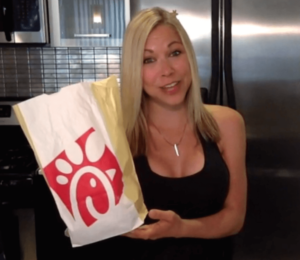 GiGi Eats Celebrities holds a chick-fil-a bag 